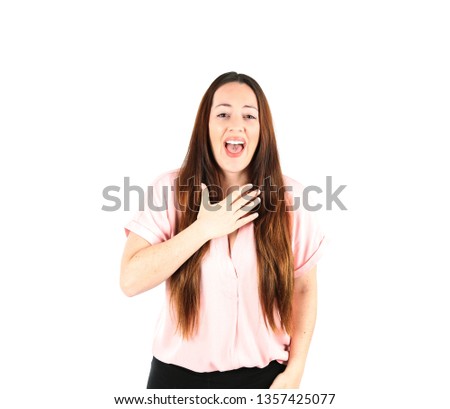 Excited young woman putting her hand on her chest against a white background