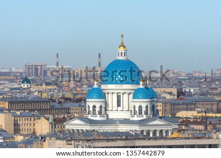 Trinity Cathedral with a blue dome and gold stars on the background of roofs in the city of St. Petersburg