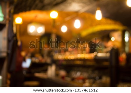 Blurred bar or cafe interior background with bokeh effect. 