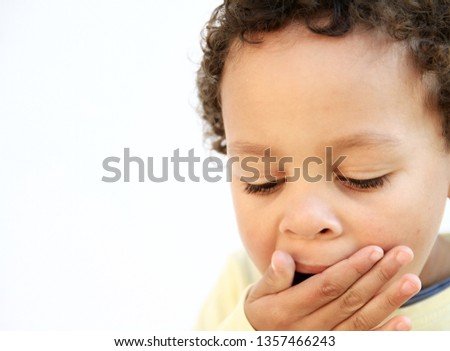 little boy yawning with open mouth on white background stock photo