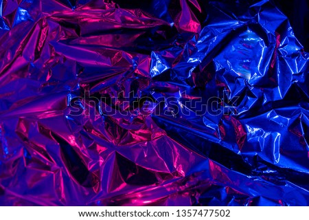 Holographic neon blue and purple foil background   Multicolor trendy backdrop.