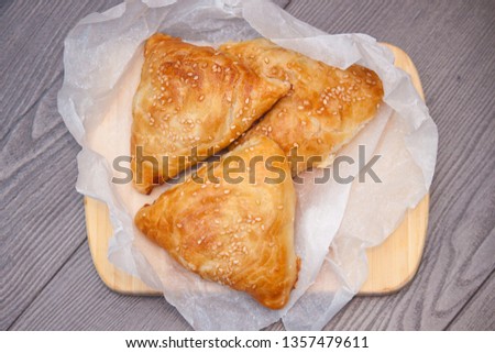 Indian, Asian food delicious samsa or samoses on wooden background. Top view, flat lay. Royalty-Free Stock Photo #1357479611
