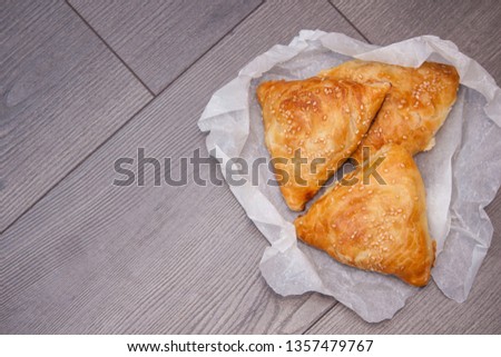 Indian, Asian food delicious samsa or samoses on wooden background. Top view, flat lay. Copy space. Royalty-Free Stock Photo #1357479767