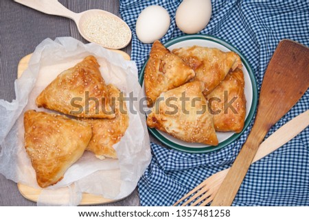 Indian, Asian food delicious samsa or samoses on wooden background. Top view, flat lay. Royalty-Free Stock Photo #1357481258