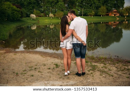 photo of back. Couple hold heir hands in back pockets