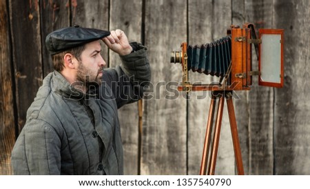Selfie of old fashioned man on large format camera. Idea- retro photography