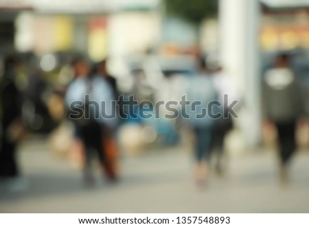 People walking in the street, blurry