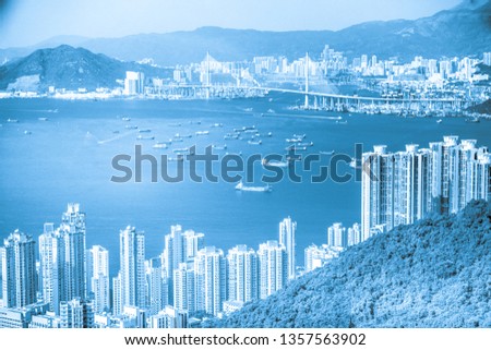 Hong Kong Skyline View From park in Victoria Peak. Kowloon districts and Victoria harbor are visible in distance.
