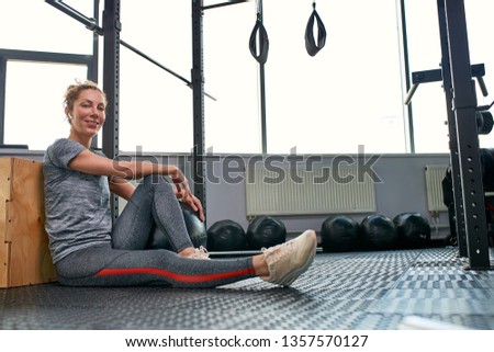 Woman doing exercises with fitball in fitness gym class. Engaging core abdominal muscles. Image concept of healthy lifestyle for women.