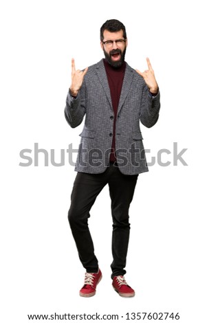 Handsome man with glasses making rock gesture over isolated white background