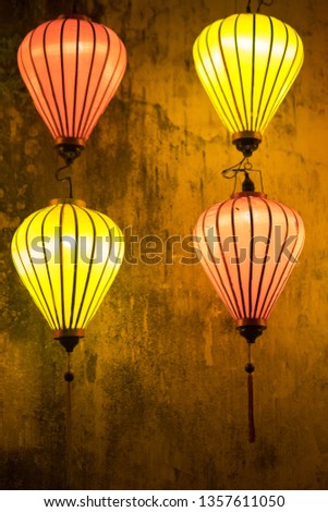 Traditional Vietnamese lantern or paper lamp are lighting at public street in Hoi An, the world heritage old town of Vietnam. Selected focus photo.