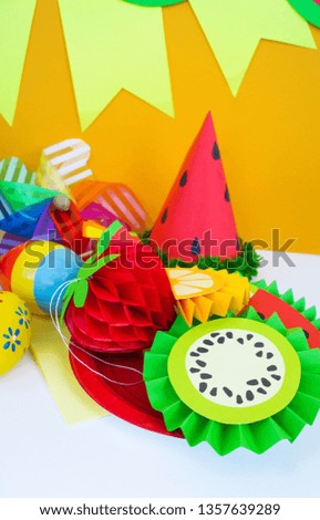 Decor for a holiday of children's birthday. Fruit party. Cake and sweet candy. Disposable tableware and tropical fruits.