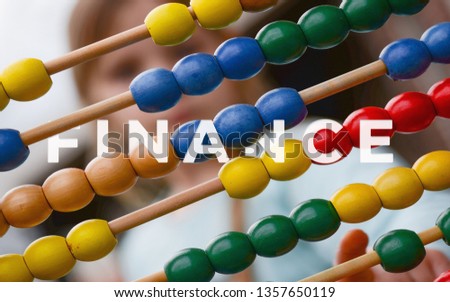 A picture of word finance with colorful abacus.