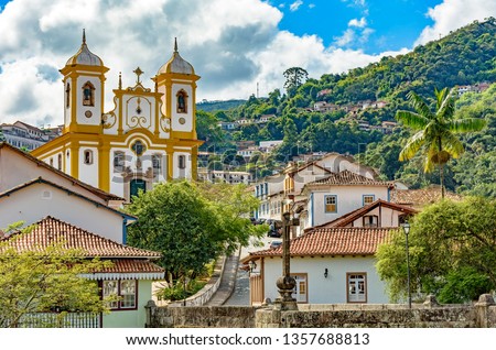 Top view of the center of the historic Ouro Preto city in Minas Gerais, Brazil with its famous churches and old buildings with hills in background Royalty-Free Stock Photo #1357688813