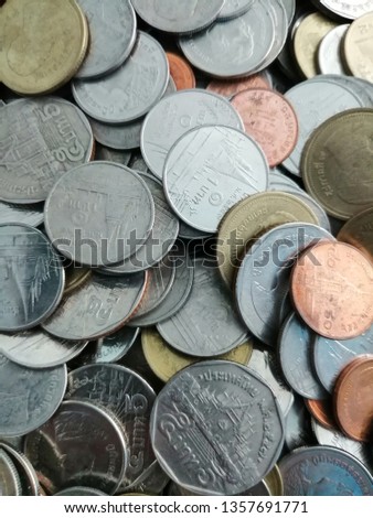 A pile of Thai coins, selective focus and blurred photo for business and finance background.