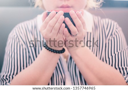 Closeup image of Young woman holding and drinking hot coffee or hot tea with feeling good. refreshing moment.