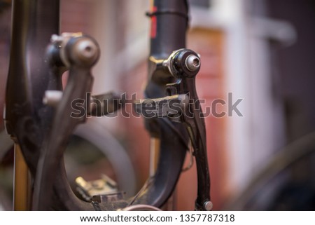 worn brake pads. male mechanic making service in bicycle repair shop, repairman fixinig bike brakes using special tool