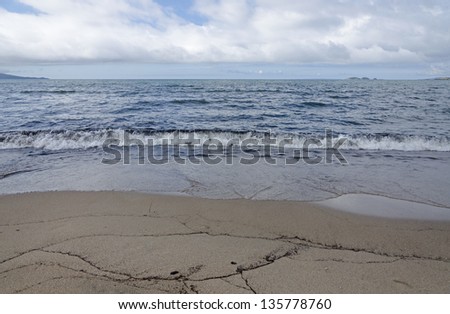 Lake Superior Shoreline. Waves come to a shore of sand