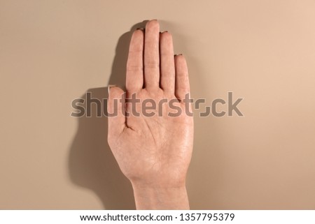 Woman showing palm on color background, top view. Chiromancy and foretelling