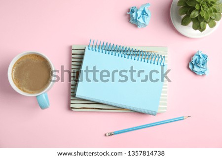 Flat lay composition with notebooks and coffee on color background
