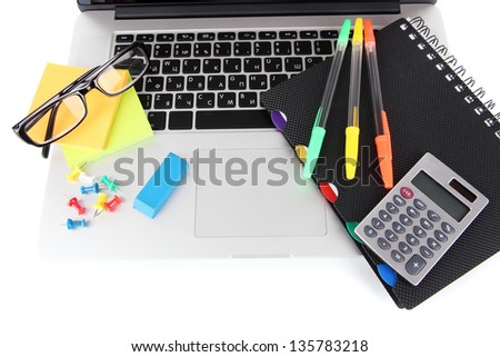 Laptop with stationery isolated on white