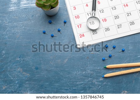 Concept image of business and meetings. Calendar to remind you an important appointment and Magnifying glass