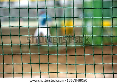 Baseball field protection net: batting-practice pitcher to throw the ball to the batter Royalty-Free Stock Photo #1357848050
