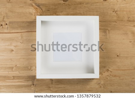white frame on wooden background