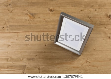 silver frame on wooden background