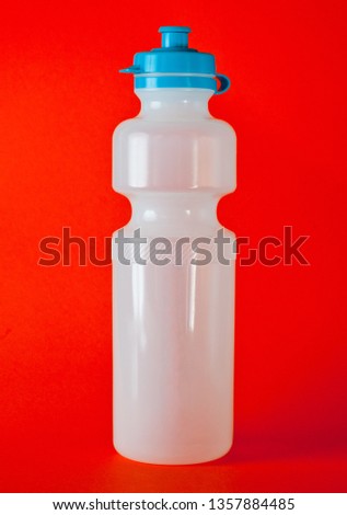 Plastic transparent bottle with blue cap for cycling and fitness.