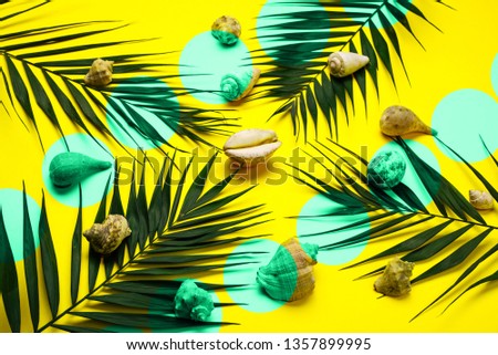 Flat lay traveler accessories with palm leaf, seashells . Top view travel or vacation concept. Summer background.