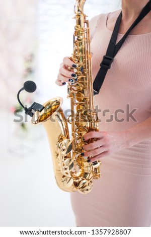 Beautiful girl playing saxophone
