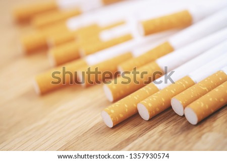 image of several commercially made cigarettes. pile cigarette on wooden. or Non smoking campaign concept, tobacco Royalty-Free Stock Photo #1357930574