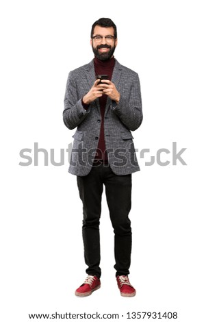 Handsome man with glasses sending a message with the mobile over isolated white background