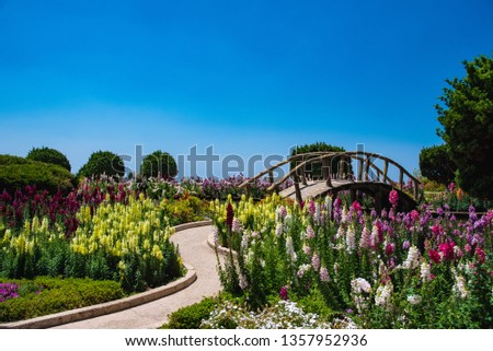 Bridge in flowers against the blue sky Royalty-Free Stock Photo #1357952936
