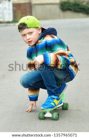 Portrait of a boy with a skate on a spring walk . The concept of active recreation for children