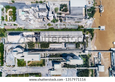 Aerial view of Hiep Phuoc cement plant with harbour bridge for unloading cement. Ho Chi Minh, Vietnam.