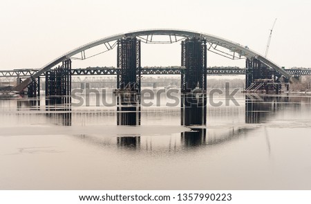 Dnepr River. Construction of a new bridge for the metro. Spring. Picture taken in Ukraine. Kiev region. Vertical frame. Black and white image
