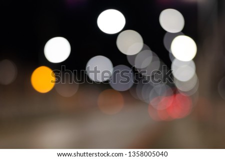 Defocused  background of city road with brightly glowing street lights.
