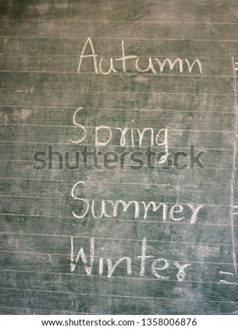 Name of the seasons of the world on a chalk board in the classroom, educational concept of school chalk board in countryside area