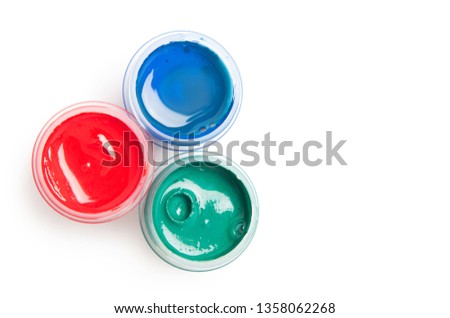 Three tubes of gouache or acrylic paint on a light background top view. RGB color isolated on white background.