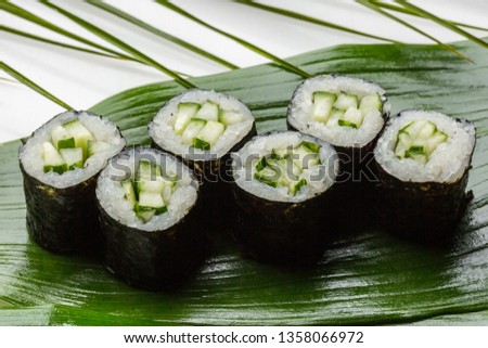 Classic sushi rolls with cucumber and sesame. Background.