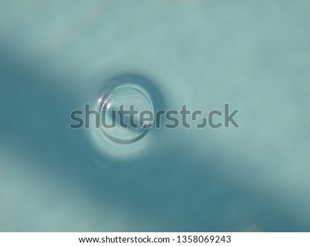 Beautiful close up of a water bubble reflecting in the sun. There is space left for advertising.