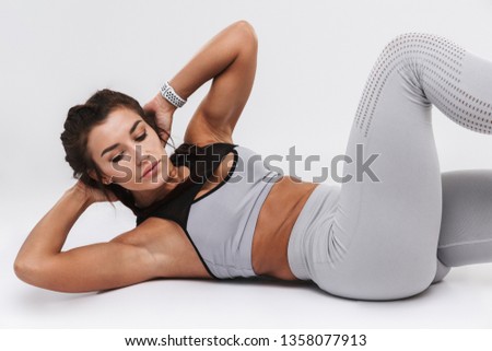Picture of a beautiful young amazing strong sports fitness woman posing isolated over white wall background make exercises.