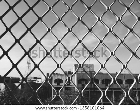 black and white photo of grid and seeing through building