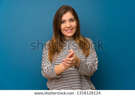 Young girl with striped shirt applauding