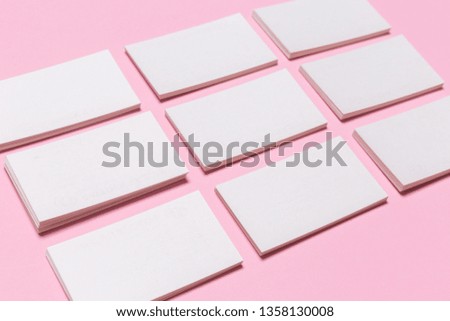Blank white business cards on pink background. Mockup for branding identity. Template for graphic designers portfolios. Top view. 