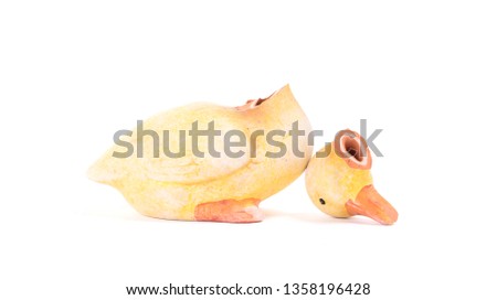 Broken statue of a duckling, isolated on white
