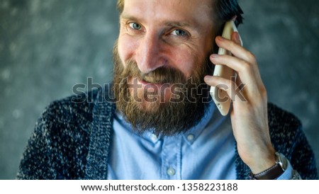 Happy Bearded Man Talk at Phone. Open and Friendly Communication with a Pleasant Interlocutor. Good News Concept