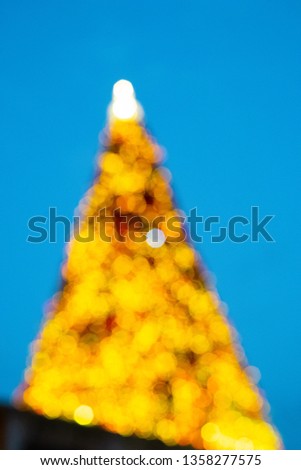 Blur of the Christmas lights on the Christmas tree with blue sky and beautiful bokeh